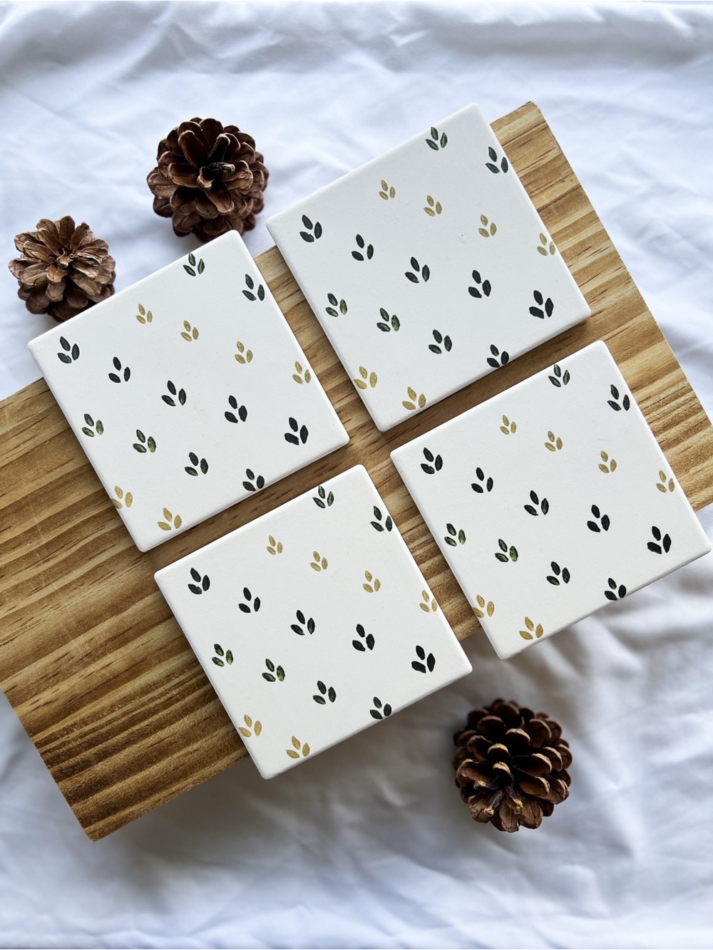 Handcrafted White Ceramic Coaster Set with Dark Green and Gold Leaf Pattern